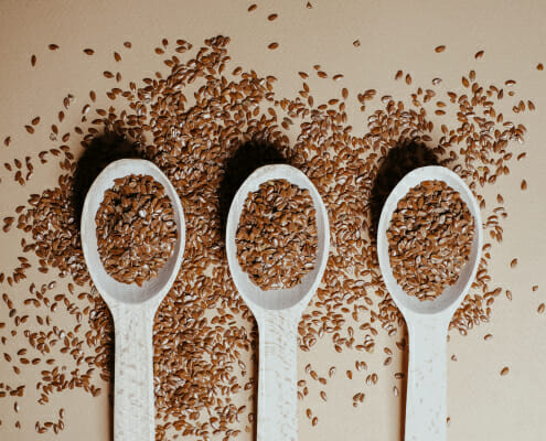 Three spoons full of flaxseed, an ingredient often included in horse diets