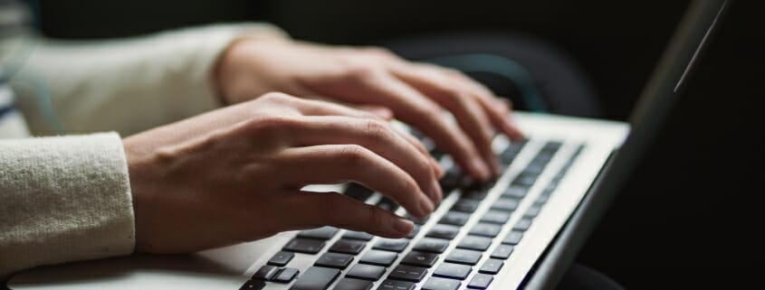 Woman's hands on laptop keyboard
